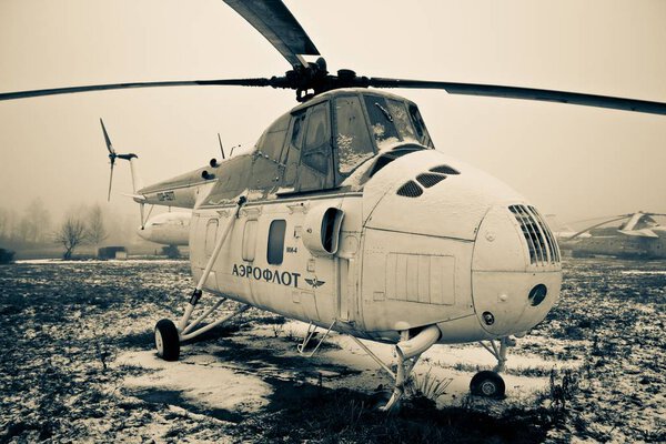 ULYANOVSK, RUSSIA - 9 DECEMBER 2012. An Aeroflot helicopter in Ulyanovsk Aircraft Museum in winter. Low color saturation for a faded retro or vintage effect and a foggy weather