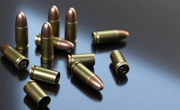Pistolenpatronen Kaliber 9 mm auf grauem Hintergrund. — Stockfoto