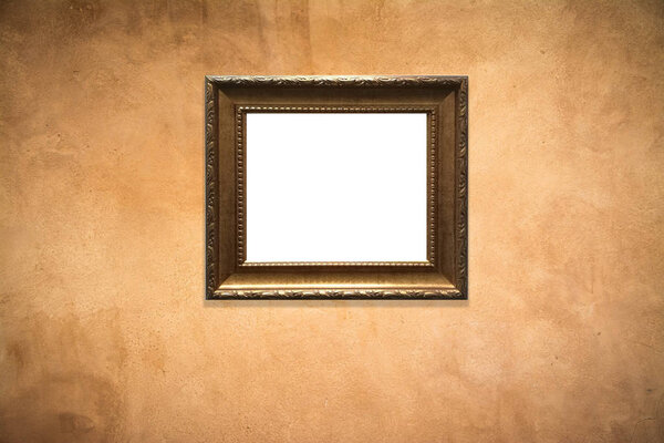Wooden picture frame on old wall background