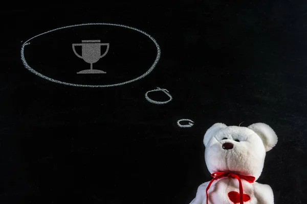 一只泰迪熊的梦想。泰迪熊与奖杯图标 — 图库照片