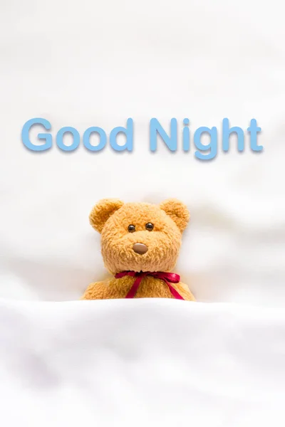 Teddy Bear lying in the white bed with message " Good night " — Stock Photo, Image