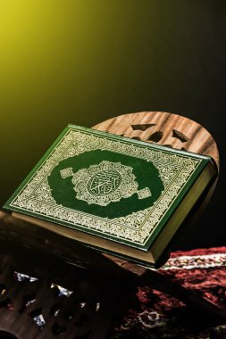 Koran - holy book of Muslims on the carpet clipart