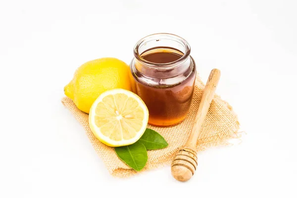 Honey with lemon on white background — Stock Photo, Image