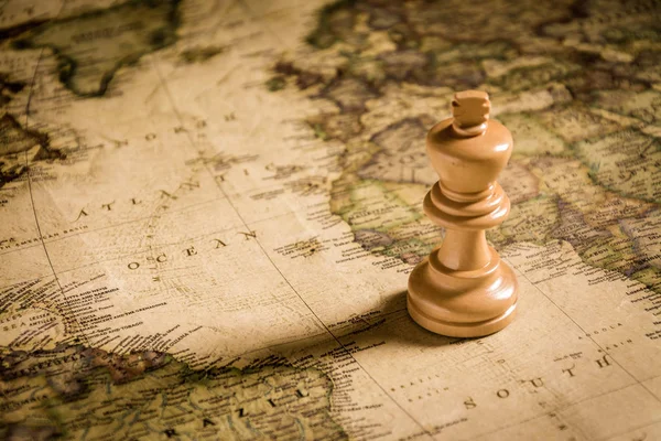 Compass and Chess on old map Stock Photo by ©kwanchaidp 75914687