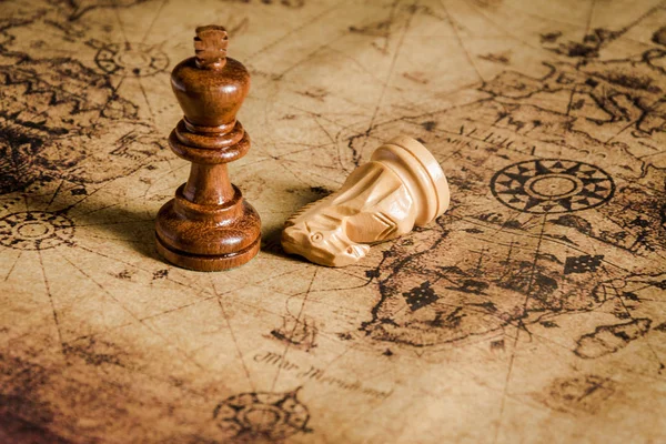 Compass and Chess on old map Stock Photo by ©kwanchaidp 75914687