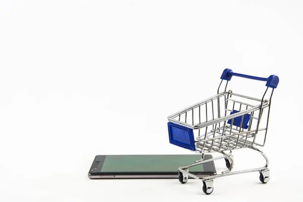 Smart phone with shopping cart on white background , Means shopp — Stock Photo, Image