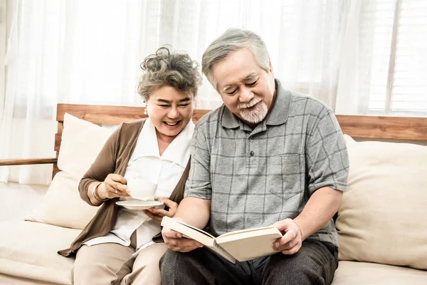 Asiático anciano pareja sentado juntos en la sala de estar de lectura — Foto de Stock