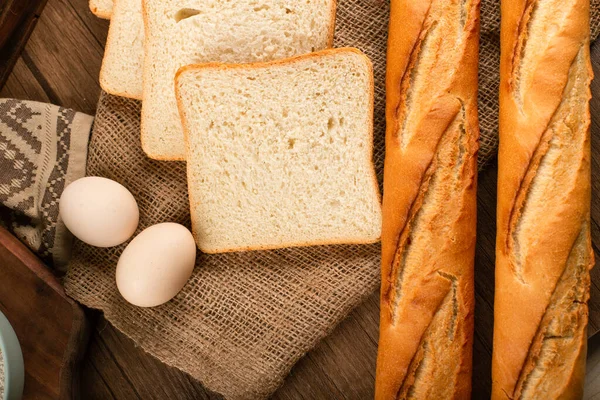 Baguette with slices of bread and eggs — Stock Photo, Image