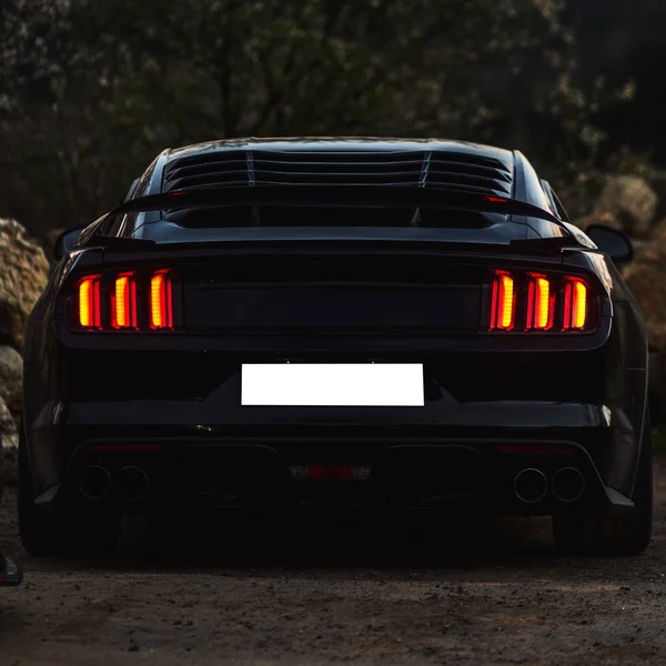 Black car with red and yellow xenon lights — Stock Photo, Image