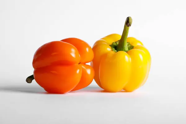 Sárga és narancs színű paprika fehér alapon — Stock Fotó