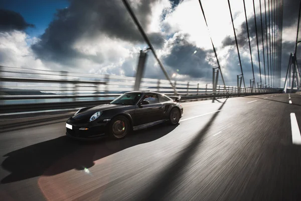 Brand new luxury sport sedan car on the metallic design bridge — Stock Photo, Image