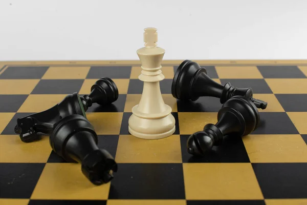 Biały król wygrał czarne figury na szachownicy — Zdjęcie stockowe