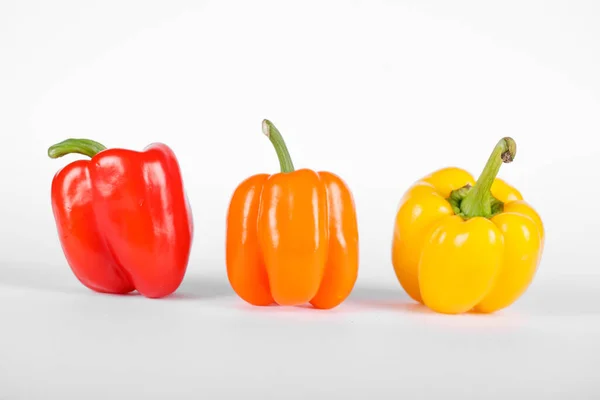Red, orange and yellow color peppers on white background — Stock Photo, Image