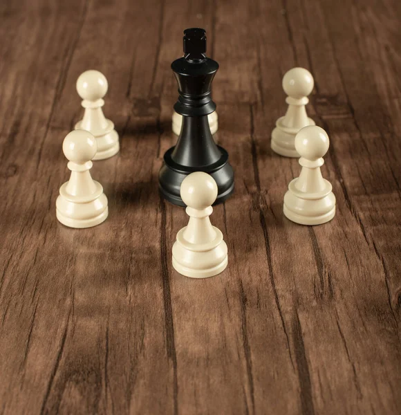 A black king with white pawns around