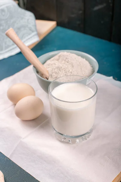 A cup of milk, eggs and a flour bowl — Stock Photo, Image