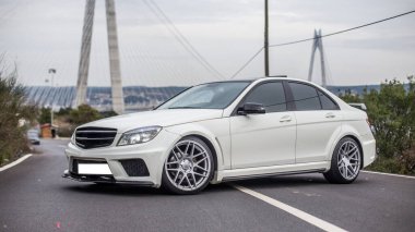 Beyaz birinci sınıf bir sedan yolun ortasına park etmiş.