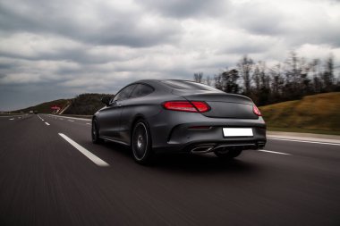 Sport sedan yolda gidiyor. kırmızı ksenon ışıkları. 