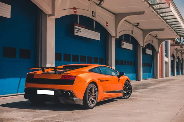 Orange color brand sport sedan with black autotuning — Stock Photo, Image