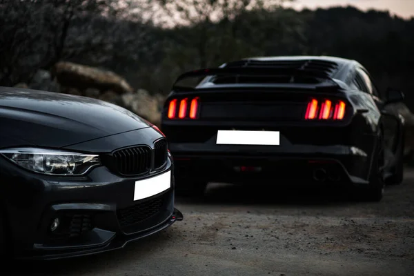 Two black luxury sport cars in parking mode — Stock Photo, Image