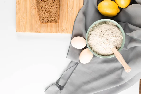 Slice of bread, flour and eggs on the table — Stock Photo, Image