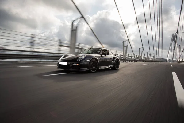 Brand new luxury sport sedan car on the bridge — Stock Photo, Image