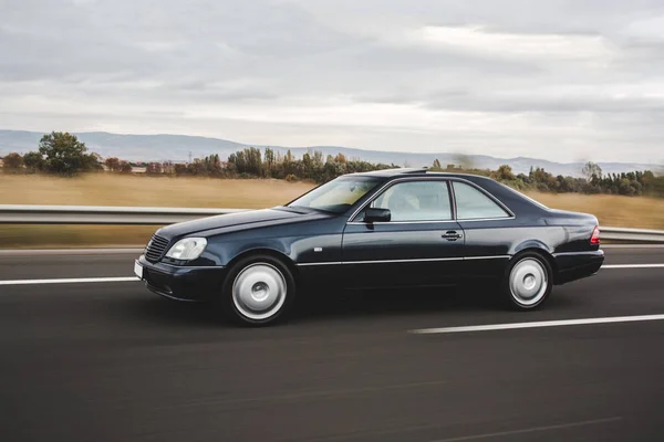 Black mid class sedan driving on the road — Stock Photo, Image