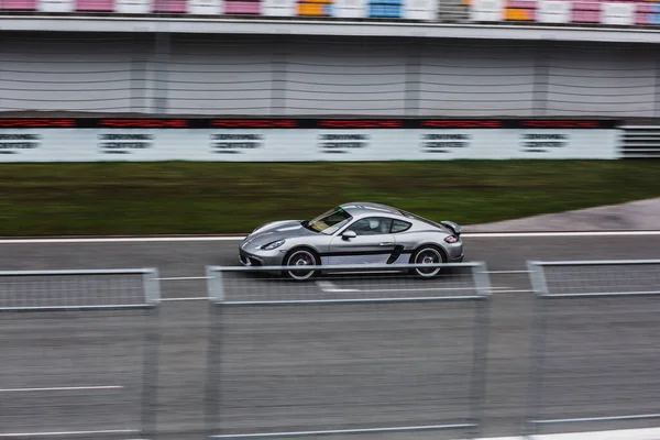 Gümüş renkli spor araba pistte yarışıyor. — Stok fotoğraf