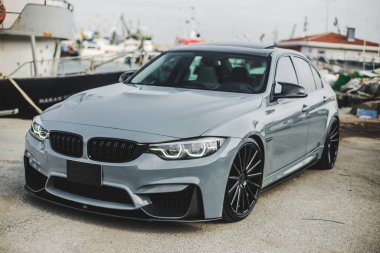 Limanda gri lüks bir sedan. Gemi arkada. ön görünüm