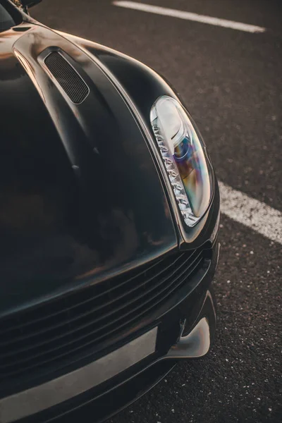 Front light and bumper of a black sport model car — Stock Photo, Image