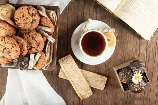 A cup of tea with oatmeal cookies and crackers. Top view Stock Photo