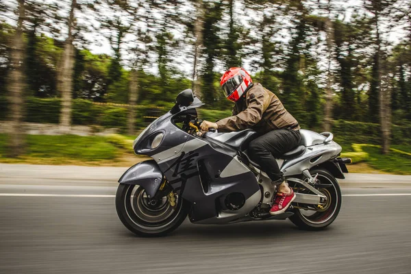 High speed motorcycle biking on the road accross the forest — Stock Photo, Image