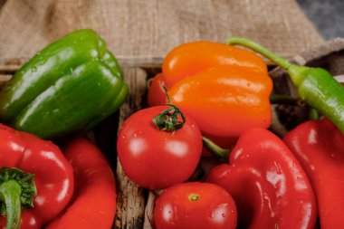 Kırsal bir tepside, üzerinde su damlaları olan mevsimlik sebzeler. Üst görünüm.