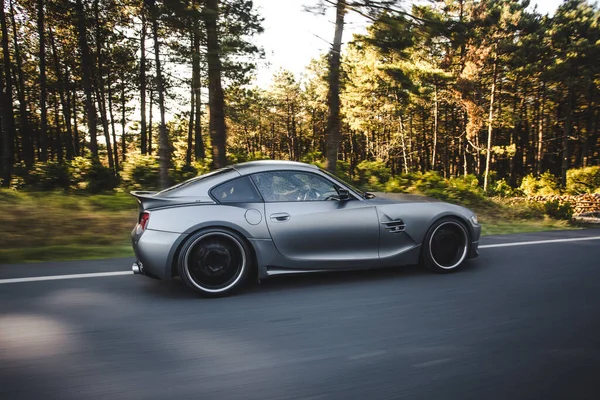 Silver sport cabriolet parked in the forest road — Stock Photo, Image