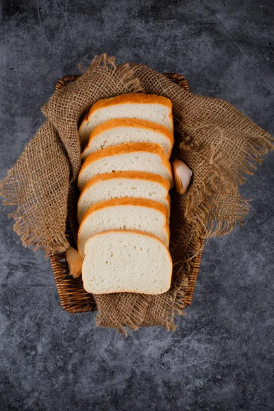Bread slices on a burlap on a blue background. — Stock Photo, Image