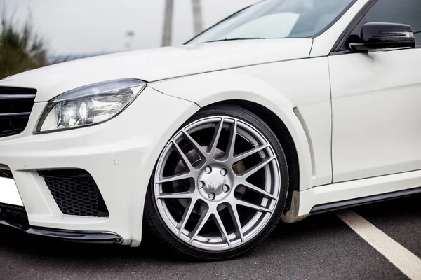 White cabriolet with xenon lights on the forest parking , front wheel and light — Stock Photo, Image