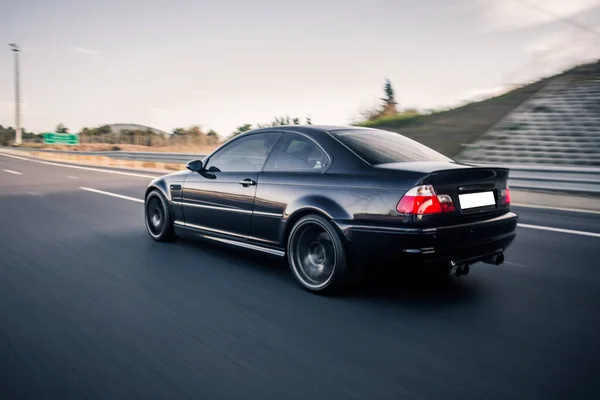 Black luxury sport car with red lights high speed driving in the shadow — Stock Photo, Image