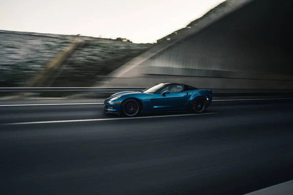 A blue brand sport model car, profile view in the evening — Stock Photo, Image