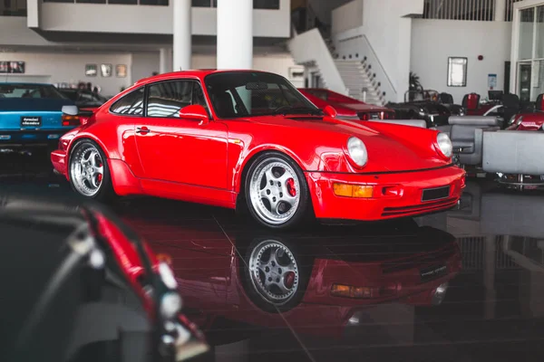 Red supercar in the autoshow on black ground — Stock Photo, Image