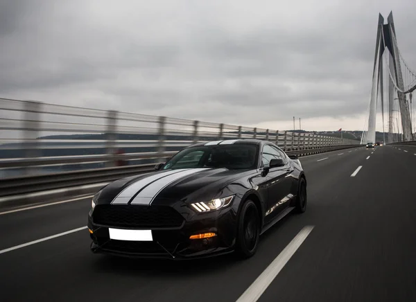 Driving a black car on the freeway over the bridge, in the stormy weather — Stock Photo, Image