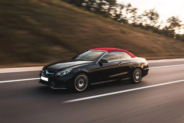 Black turbo motor sport car on the highlands , front view — Stock Photo, Image