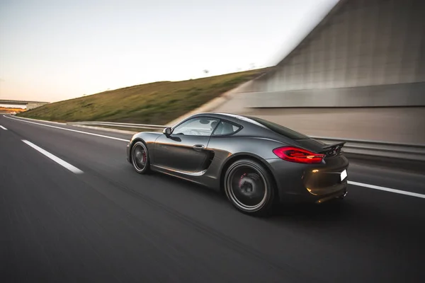 Navy blue sport car speed drive out of the tunnel — 스톡 사진