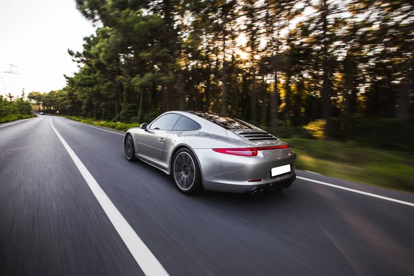 Silver sport model racing car in the autumn forest,evening drive — Stock Photo, Image