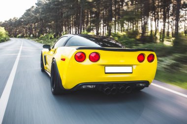 Kırmızı ksenon ışıklı sarı yarış arabası, arkadan görüş.