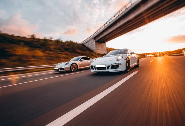 Speed motion between two sport cars under the bridge — Stock Photo, Image