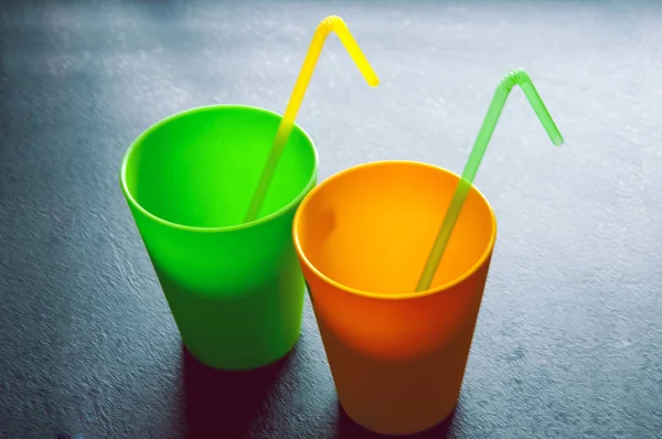 Two cups with the tube on the black background — Stock Photo, Image