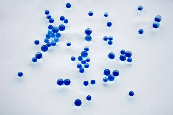 Bir sürü beyaz zemin üzerine mavi çakıl taşları — Stok fotoğraf