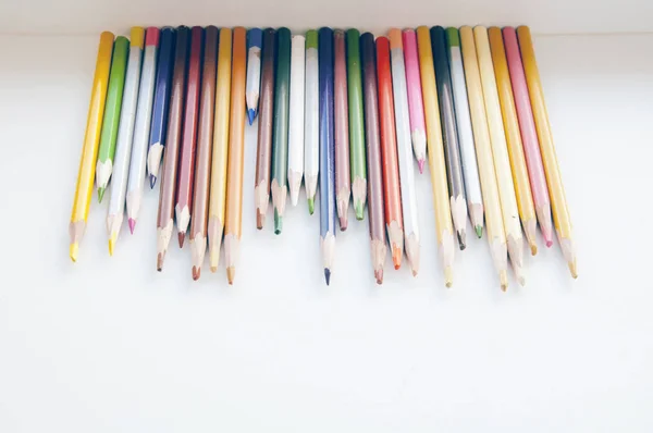 Colored pencils in a row — Stock Photo, Image