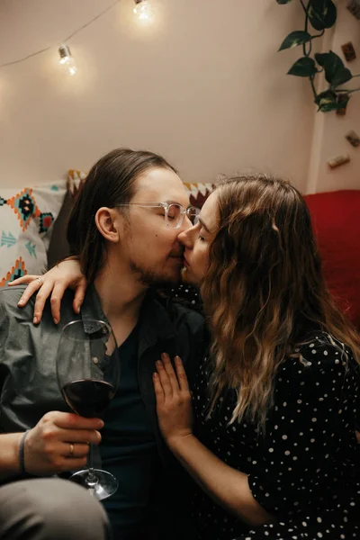 Romantic couple having dinner at home. Man pouring wine. Beautiful cozy interior — 스톡 사진