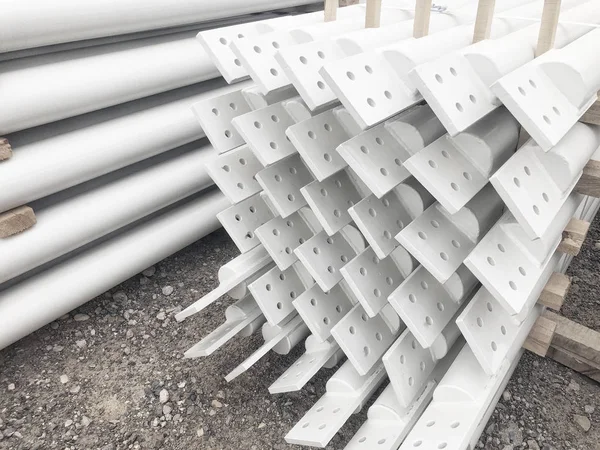 White colored stacked metal diagonal bracings with holes for bolts. — Stock Photo, Image