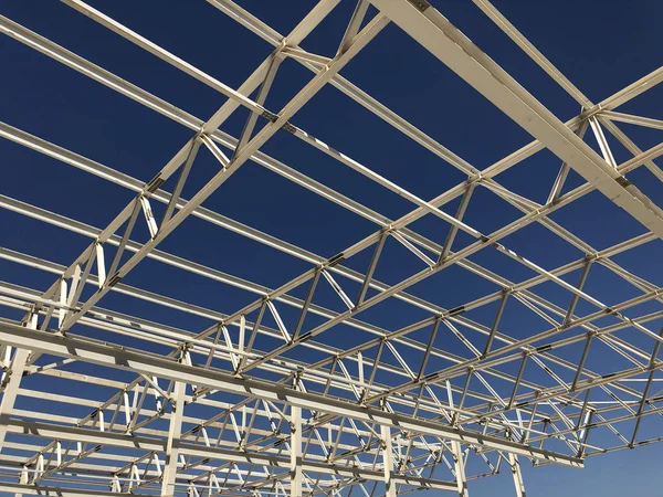 Truss ceiling and metal pillars and girders. Support constructions. Industrial building metal framework